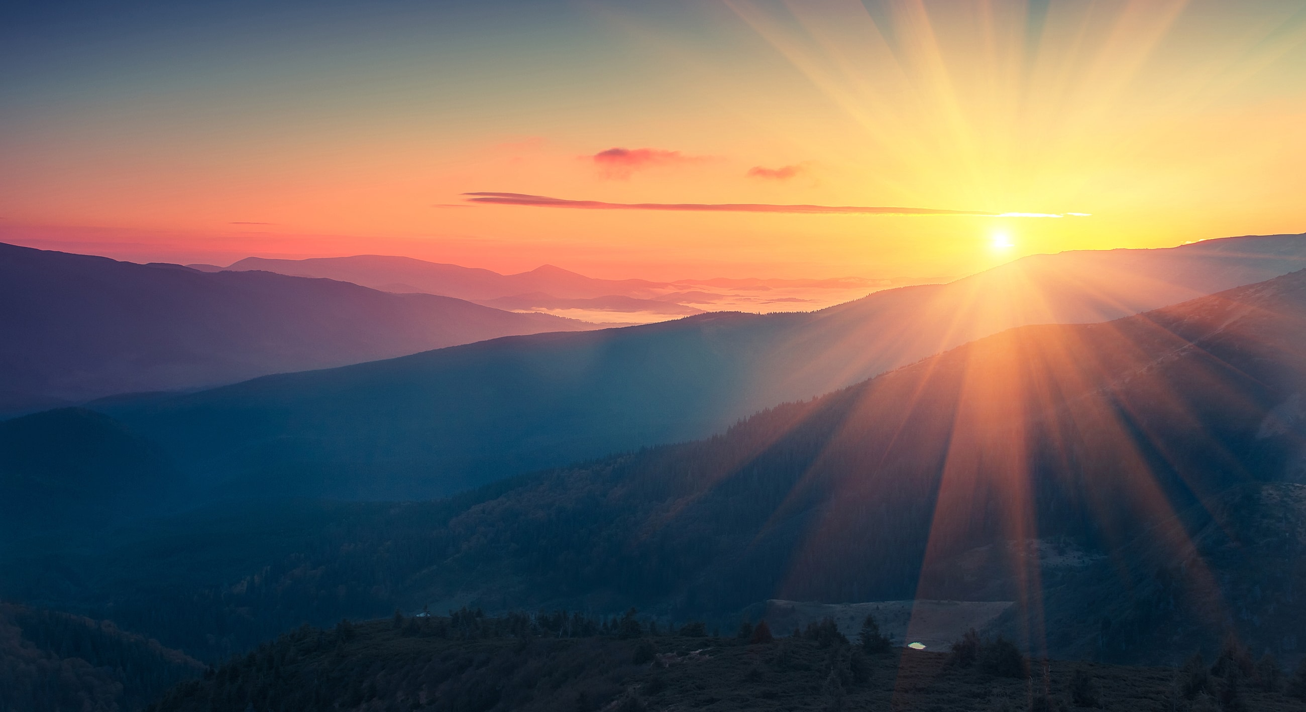 Stunning sunrise over serene mountain landscape.