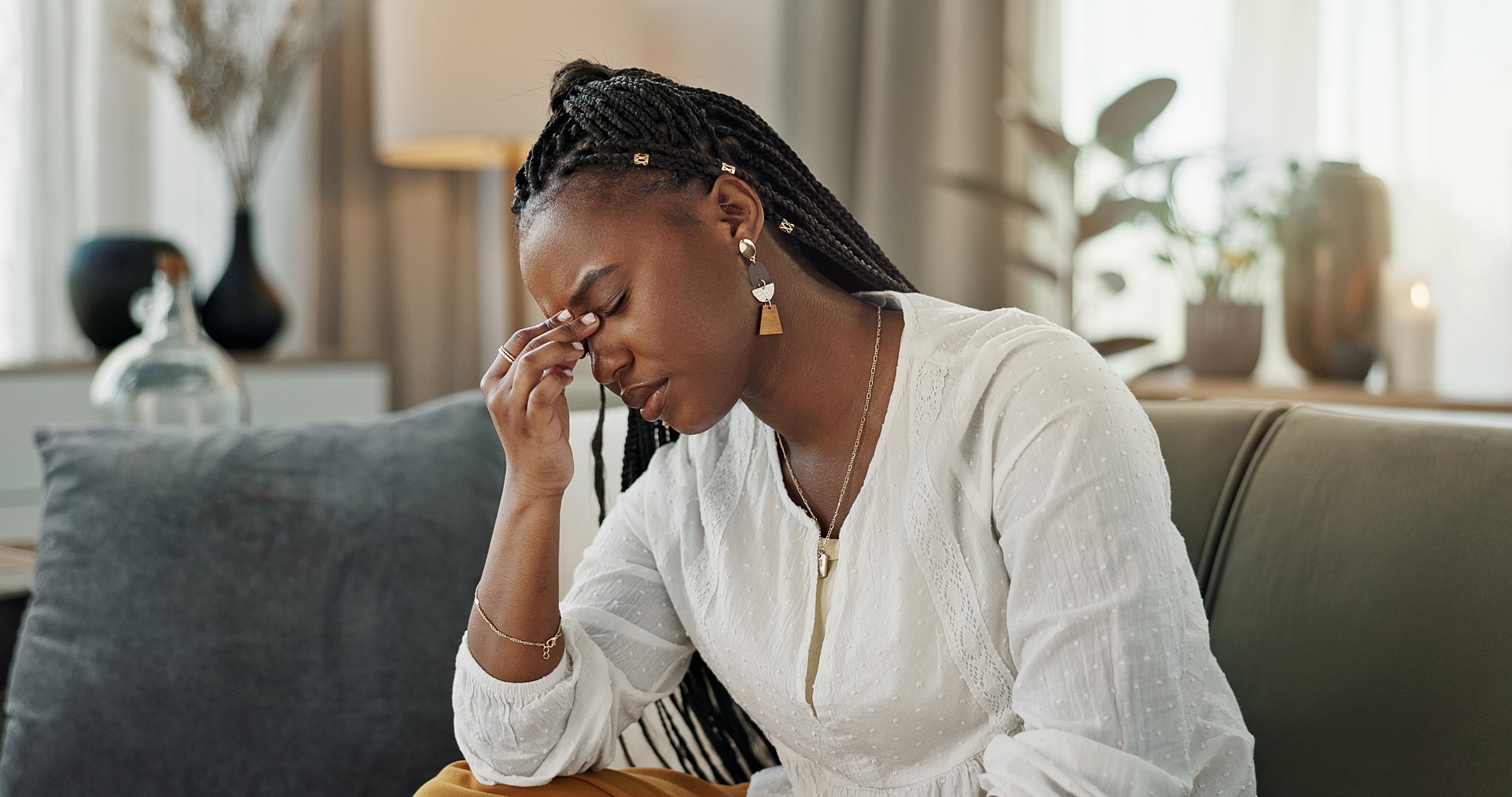 Woman experiencing stress or headache indoors.