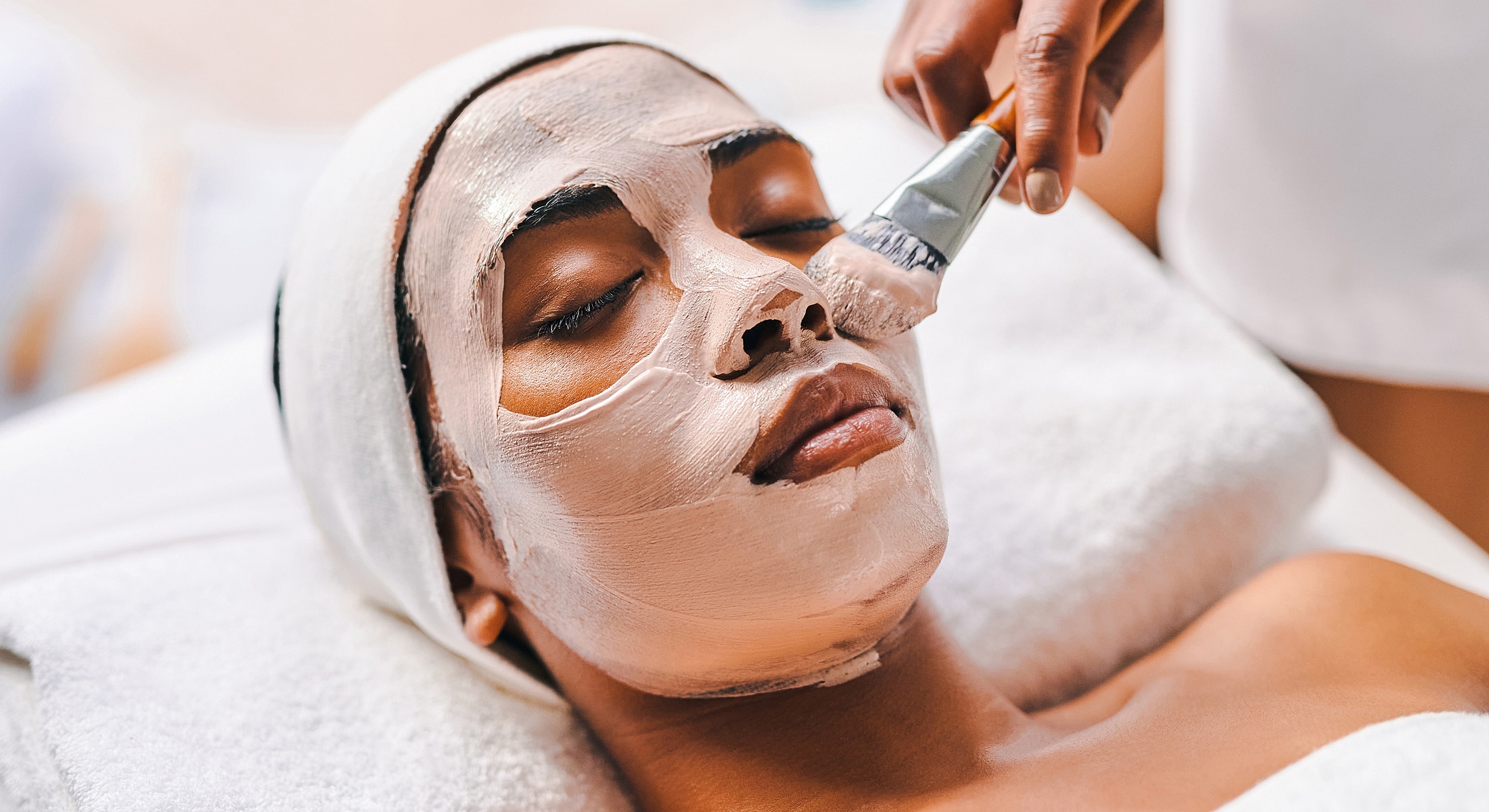 Person receiving facial treatment at spa.